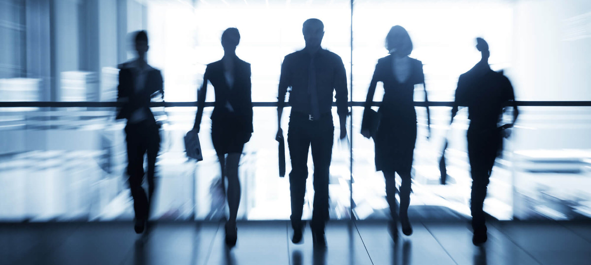 Stylized silhouette of business team walking towards the camera